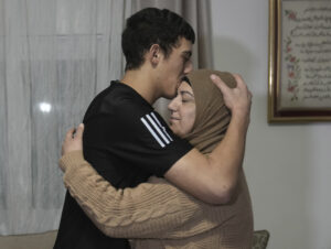 Released Palestinian prisoner Muhammad Abu Al-Humus, 17, hugs his mother after arriving home.