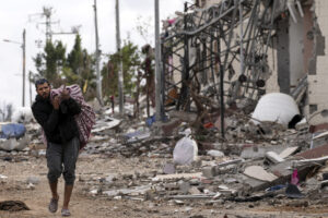 A Palestinian man collects his belongings southeast of the Gaza City.