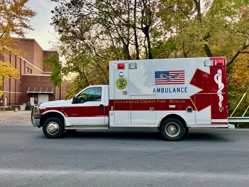 An ambulance driving down a street. 