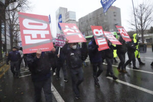 Protesters march after a rally against South Korean President Yoon Suk Yeol, with the posters read "Resign Yoon Suk Yeol", in Seoul, South Korea.