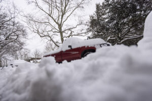 Photo of snow covering a truck.