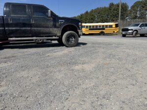 Image of school parking lot with loose gravel.