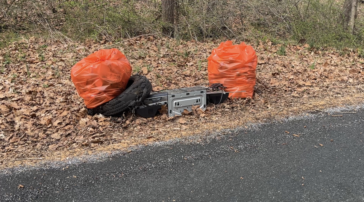 Trash bags filled with litter on the side of the road.