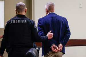 Colin Gray is handcuffed and escorted out of the room after jury deliberations