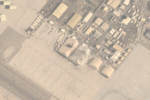 Aeriel view of Abu Dhabi base. Building has been struck. Rubble and destructed building.
