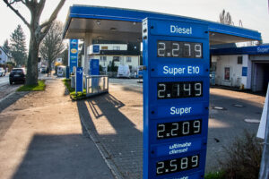Blue sign outside gas station that list the prices of diesel currently in Germany. Diesel is 2.28 