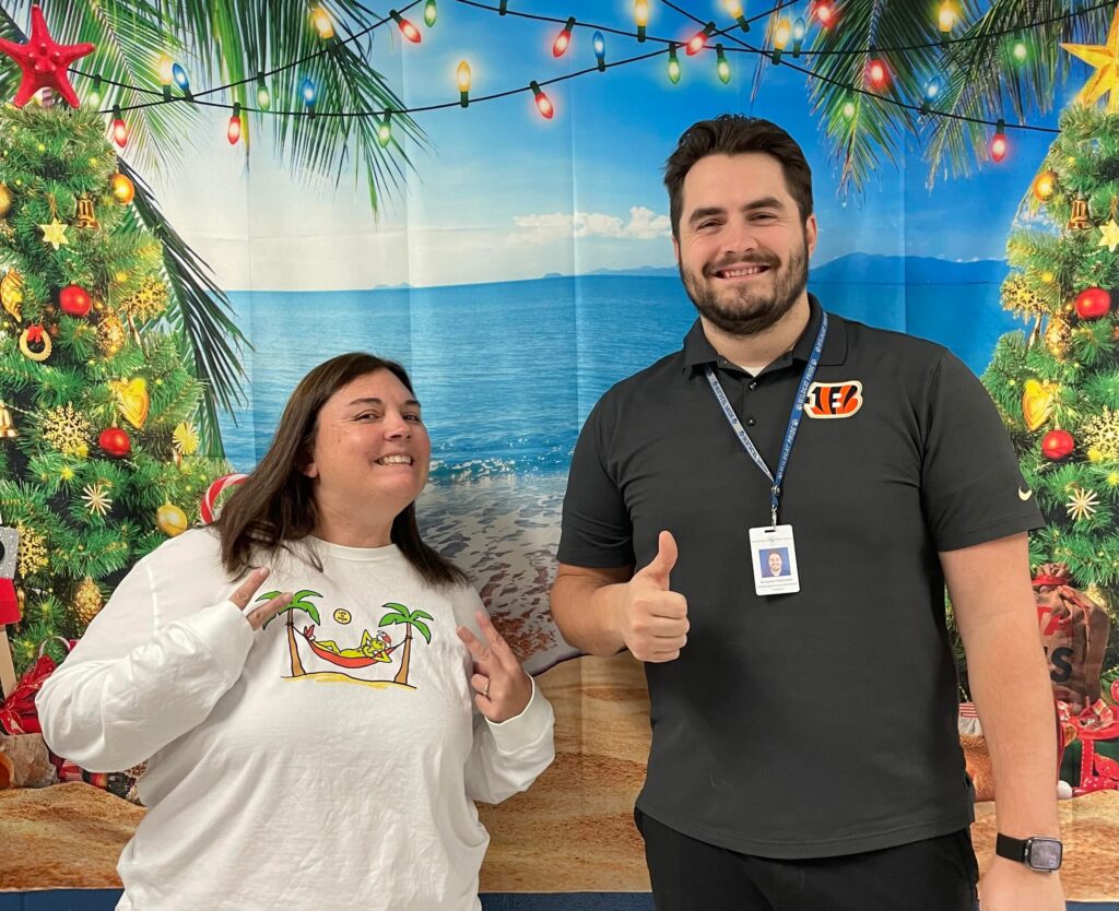 Jessika Crance, Rockbridge County High School special education teacher and transition coordinator, and Ben Kabizinski, former RCHS special education teacher, pose in front of a backdrop.