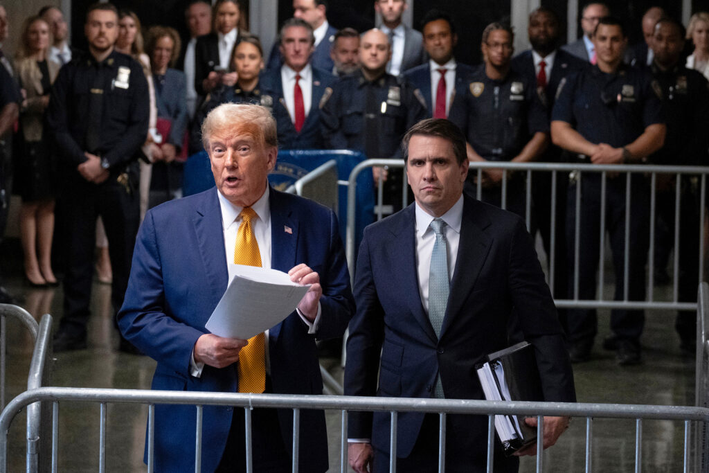  President Donald Trump, stands with then-defense attorney Todd Blanche. 