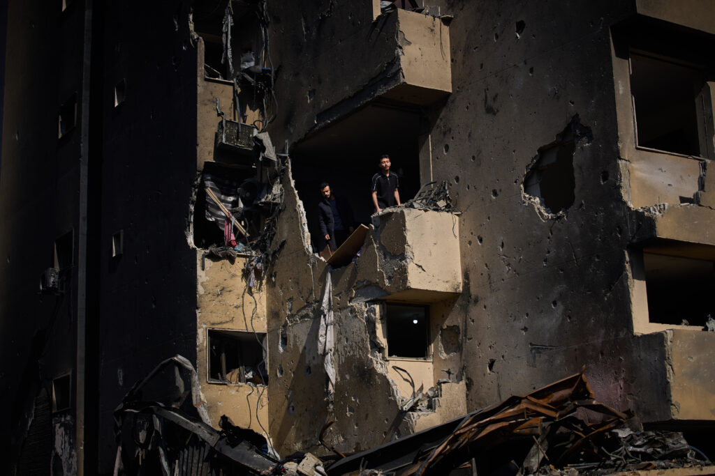 Men inspect the damage to their home destroyed in an Israeli airstrike a day earlier in Beirut, Lebanon. 